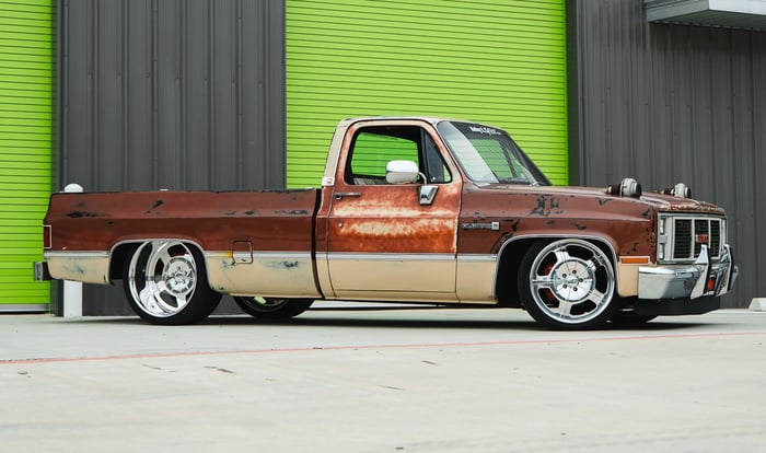 Side profile of the 1983 C10 highlighting its lowered stance and wide rear tires.