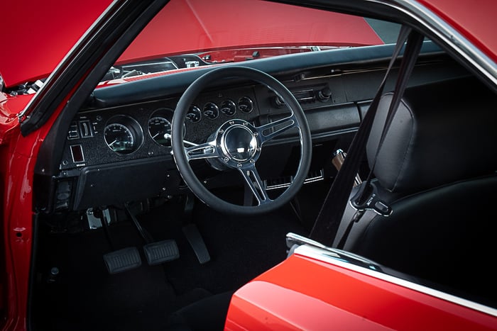 Interior overview showing Sparco bucket seats and restored rear seat.