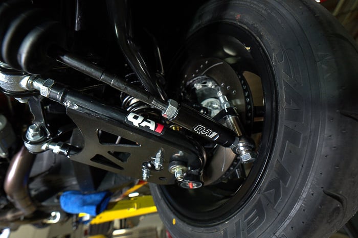 QA1 front tubular K-member and lower control arm with steering linkage visible.