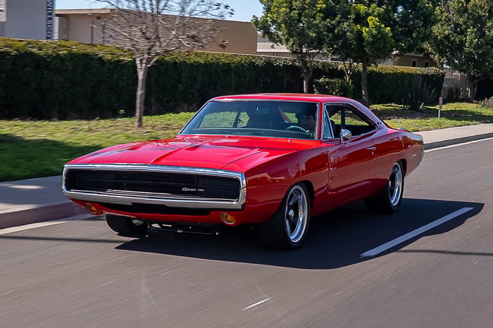 Driver-side view of the Charger highlighting the long body lines and Viper Red finish.