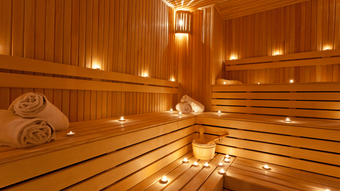 sauna for sale illustrated with white towels and wooden bucket