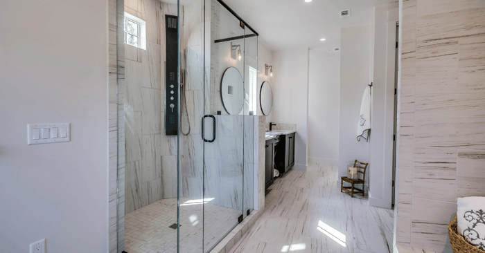 steam room shower in a bathroom with round mirrors