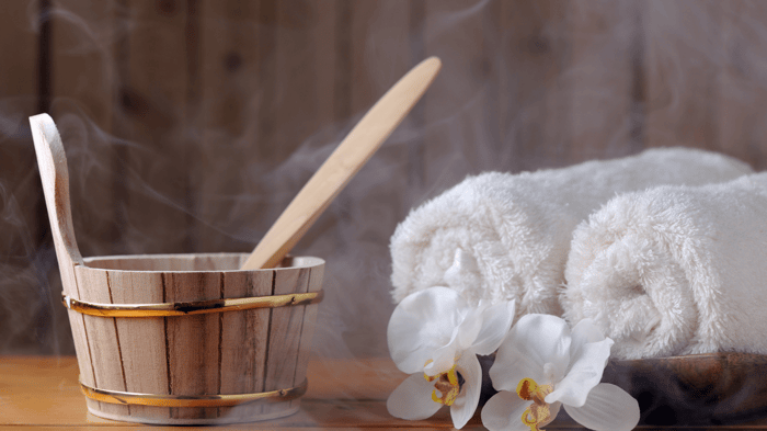 steam sauna steaming near sauna bucket and white towels