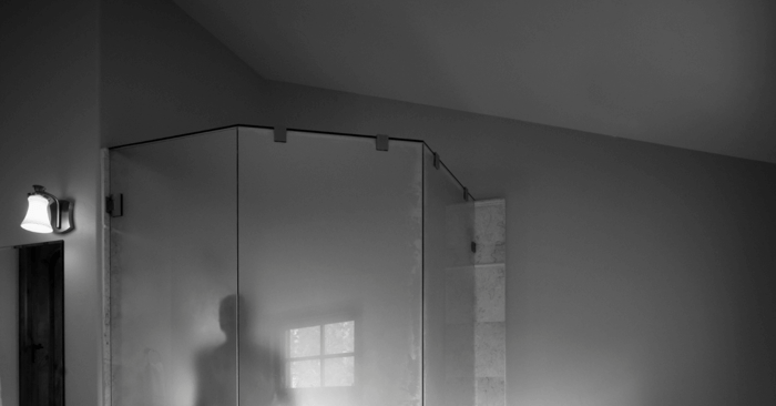 steam shower generator with a person inside the shower