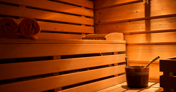 therasage sauna depicted by a sauna with water bucket and towels