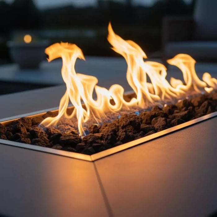 a bed of fire pit rocks burning on a fire pit table