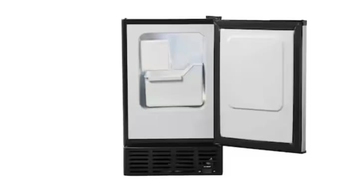 A black, under-the-counter ice maker with the door open, revealing the ice bin and a small amount of ice.