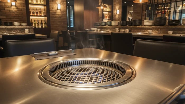 Premium stainless steel natural gas Korean BBQ table with recessed burner in upscale restaurant dining room