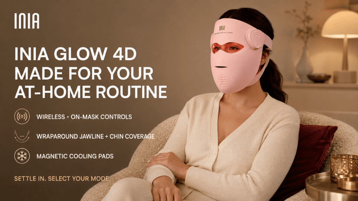 Woman wearing INIA GLOW 4D at home, with wireless controls, jawline and chin coverage, and magnetic cooling pads