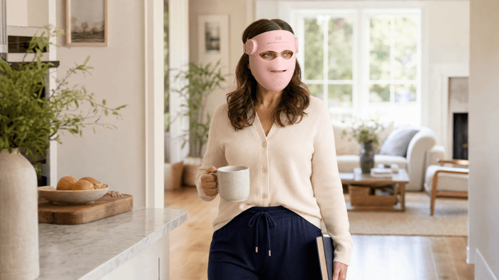 Woman moving through her home while wearing the cordless INIA GLOW 4D mask
