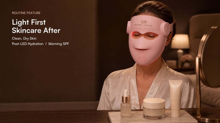 Woman wearing an illuminated INIA GLOW 4D mask with clean dry skin before post-LED hydration