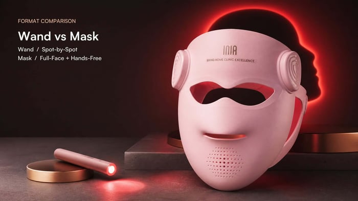 Pink INIA GLOW 4D mask beside a handheld red light wand for a red light wand vs mask comparison