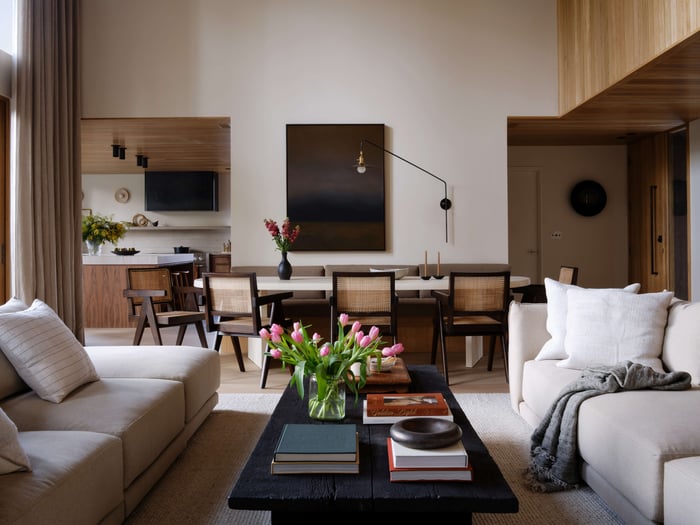 Photo of living room with two couches and tulips on the table. Interior design by Grayhaus | Photo by Luke and Mallory Leasure