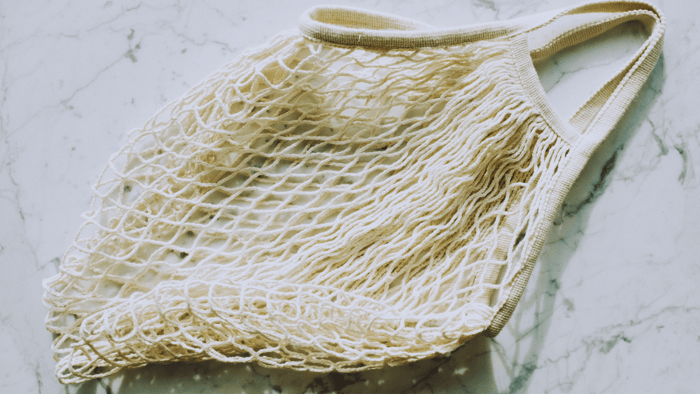 Eco-friendly string bag representing sustainable shopping options from Mudd House Mercantile and EarthHero
