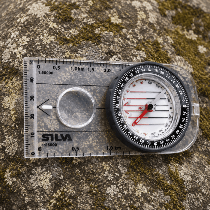 Silva Compass Field MS Compass laid out on rocky terrain