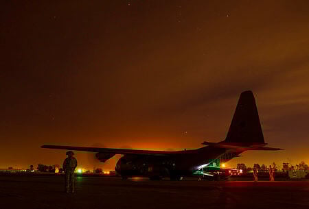 A Truck Aircraft Loading Unloading (TALU) vehicle is unloaded from a Royal Australian Air Force C-130J Hercules at the Taji Military Complex, Iraq.