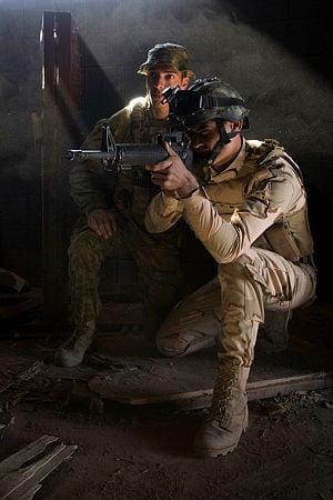 Australian Army soldier Private Mohamad Saleh observes an Iraqi Army soldier conduct a building clearance during urban training as part of the Iraqi Army's Junior Leader's Course at the Taji Military Complex, Iraq. Australian and New Zealand forces are assisting the Iraqi Army to enhance the ability of its soldiers to combat Daesh.
