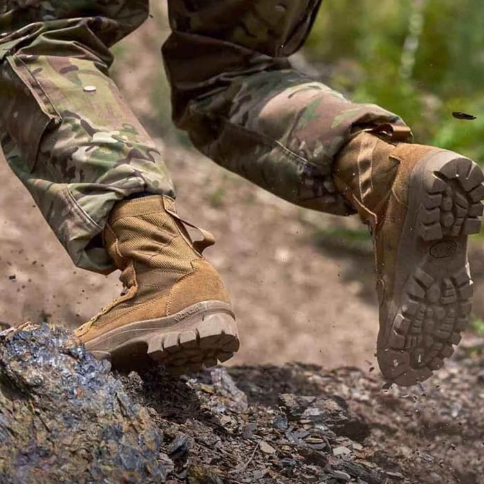 soldier stepping on rocking ledge, wearing tactical boots
