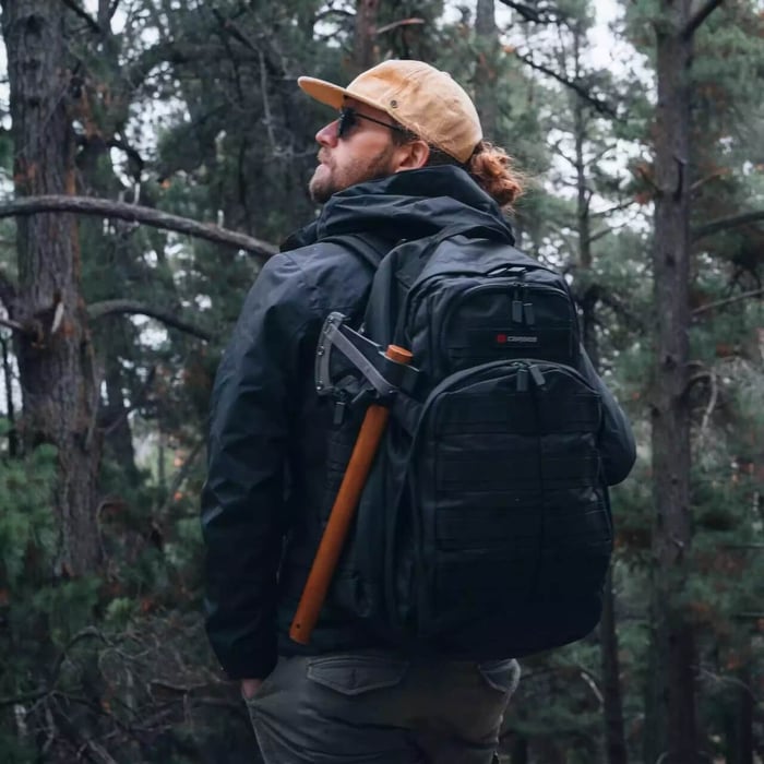 man with a black tactical backpack