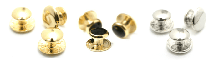 A close-up of a pair of gold buttons  Description automatically generated