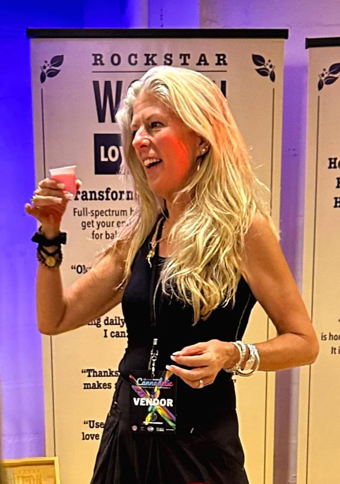 Heather toasts friends from last year at the Rockstar Blends booth | Cannadelic 2024