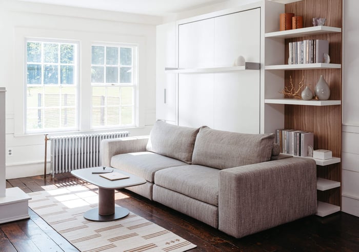 Tango Sofa Wall bed from Resource Furniture, with custom shelving and cabinet for storage