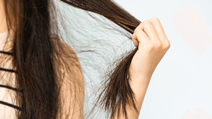 Close-Up of Woman Holding Frizzy Hair Topper.
