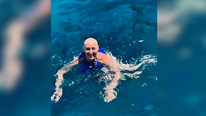 Sondra swimming in Greece without her wig.