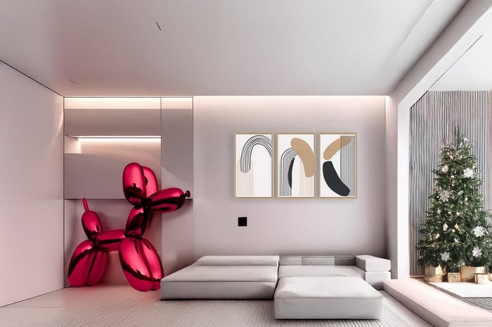Minimalist living room with modern red dog sculpture and a decorated Christmas tree next to a cozy seating area.
