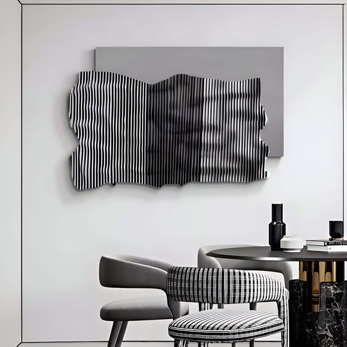 Abstract black and white striped leather wall art with wavy surface mounted above a dining area.