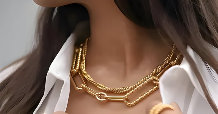 2 gold necklaces on a lady's neck