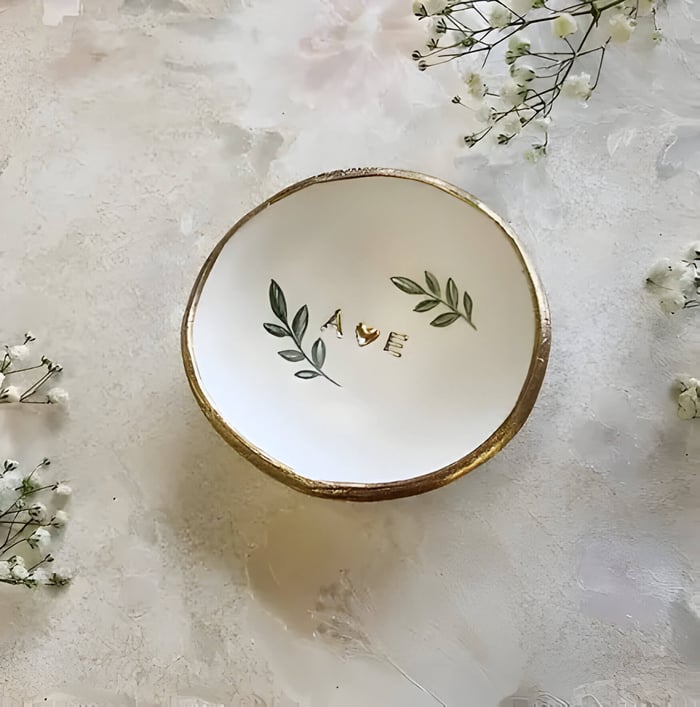 a small dish with gold lettering