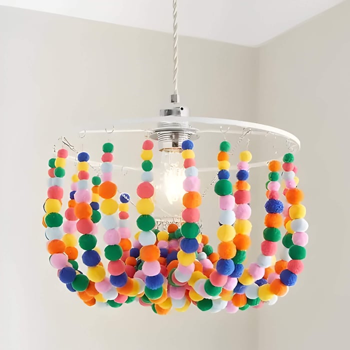 a bright and colourful pom pom light fitting