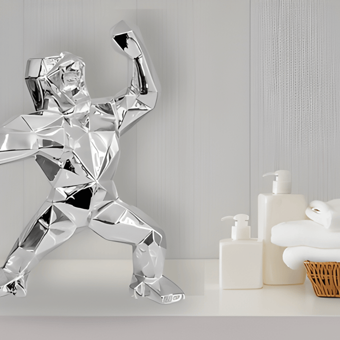 a giant bears chrome gorilla statue on a bathroom shelf
