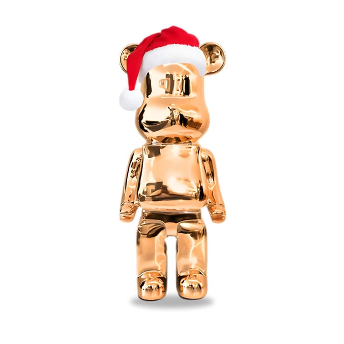 a rose gold giant bear sculpture wearing a santa hat