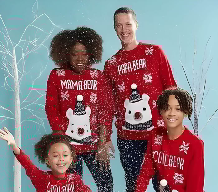 A family wearing Christmas jumpers