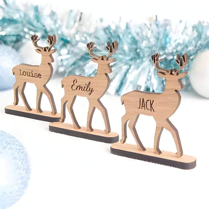 3 Wooden place cards in the shape of reindeer with names engraved in