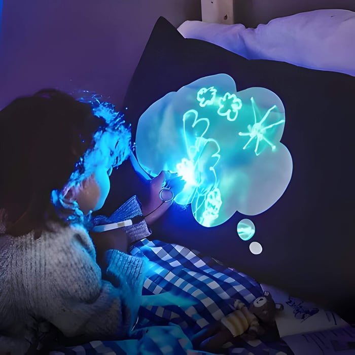 a child drawing on a glow in the dark pillow