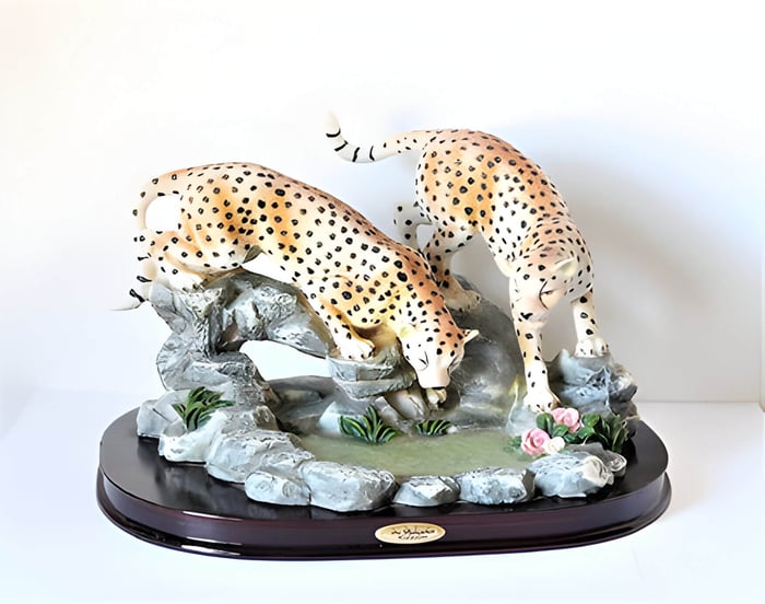 a retro vintage sculpture of 2 cheetahs