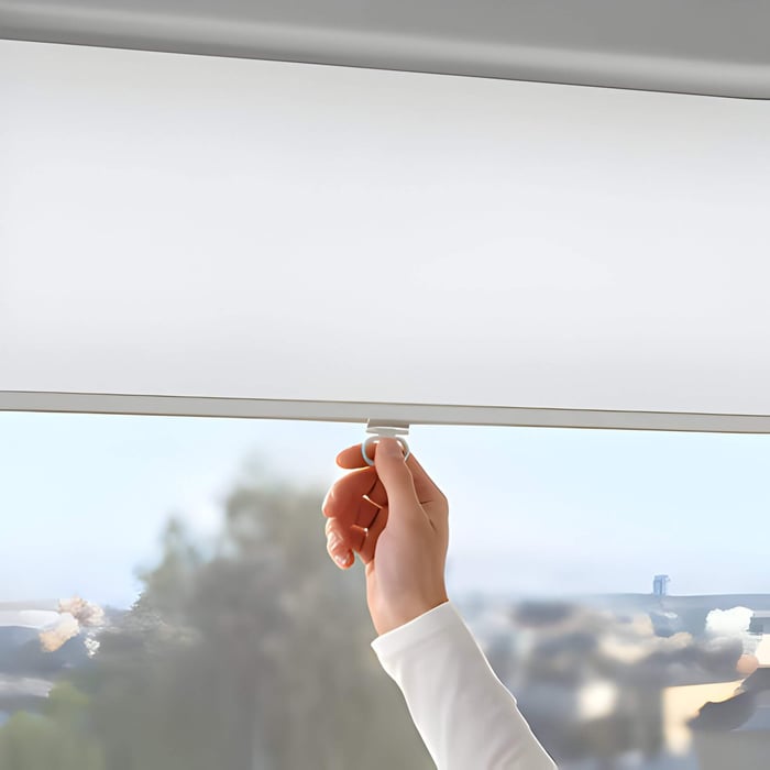 someone pulling down a white blind