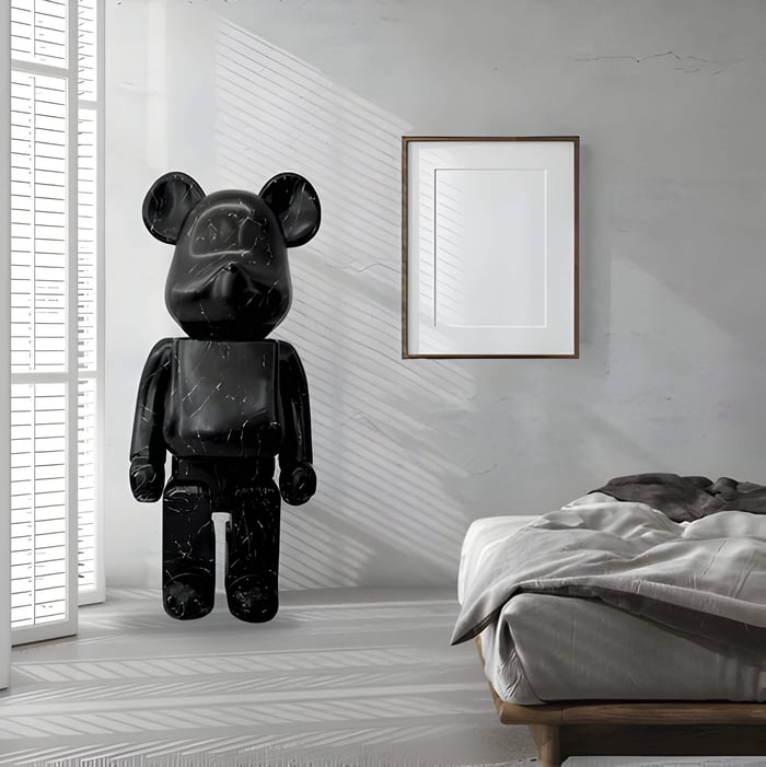 A mono tone interior with a black stone giant bear sculpture