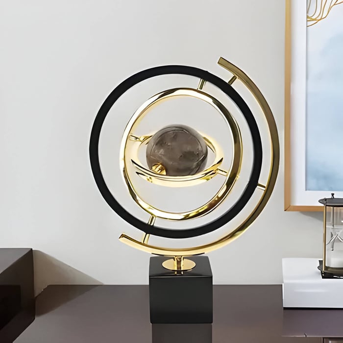 a gold and black abstract globe sculpture