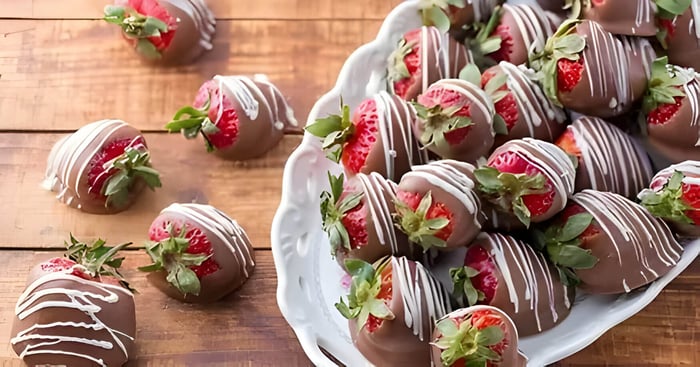 a bowl of chocolate dipped strawberries