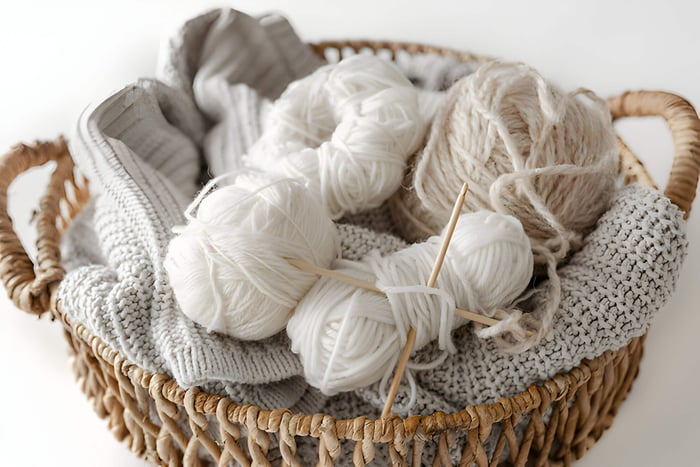 grey and white yarn in a wicker basket