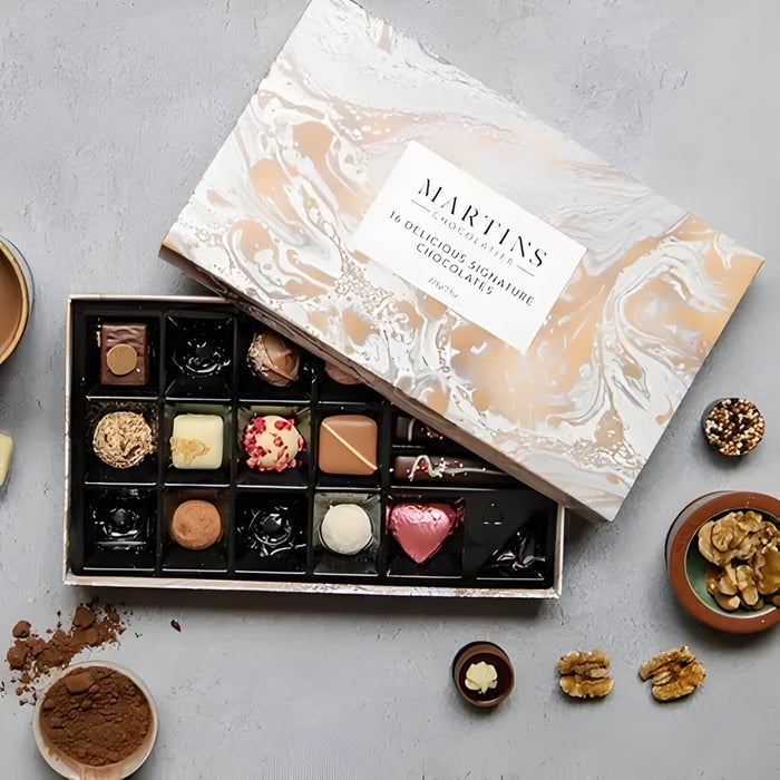 a rose gold and white marbled box of artisan chocolates
