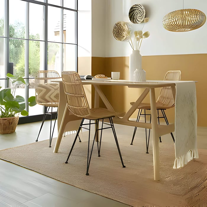 a jute rug under a dining table in a small room