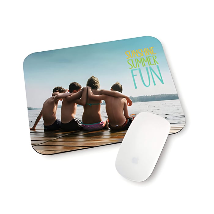 a mouse mat with a picture of 4 children at the beach  with their arms round one another
