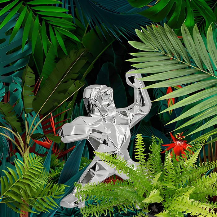 a gorilla sculpture surrounded by green foliage