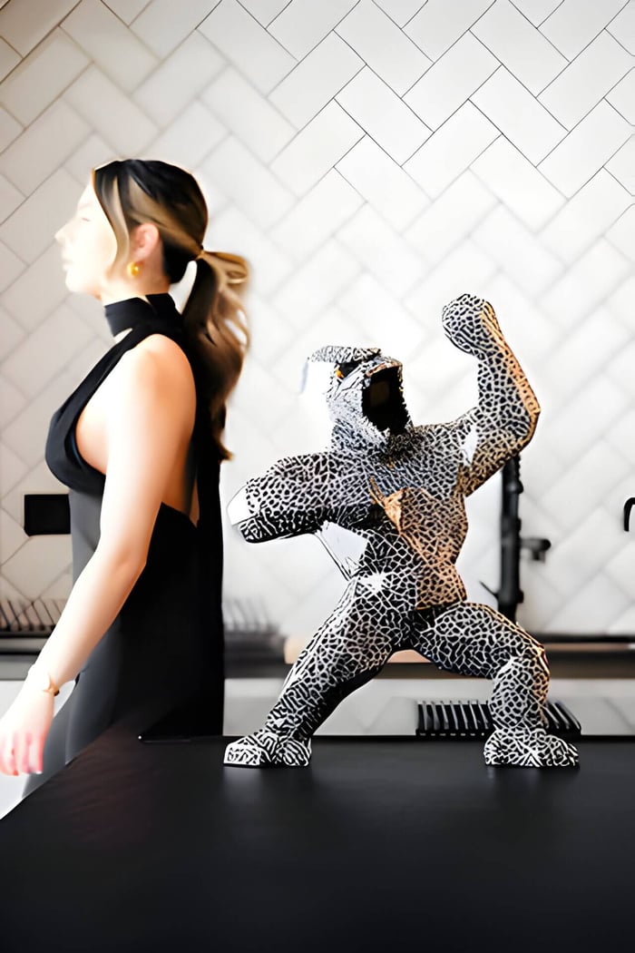 Magma gorilla sculpture in a modern home with woman walking behind