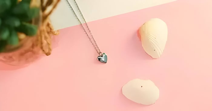 a heart necklace with cream sea shells
